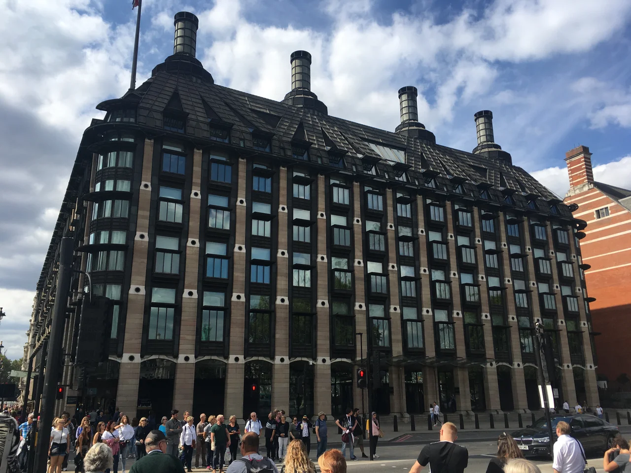 Portcullis House in Westminster, showing its repeated windows and distinctive rooftop chimneys.